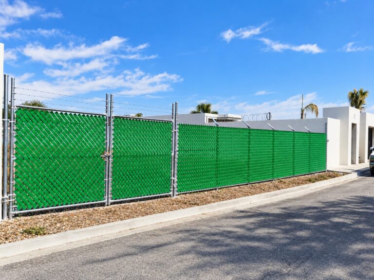 Malla ciclónica con cinta rompevientos verde en residencial de Apodaca – REGAMA